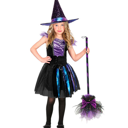 Meisje met heksenhoed met maantjes en sterren in complete heksenoutfit voor een spookfeest