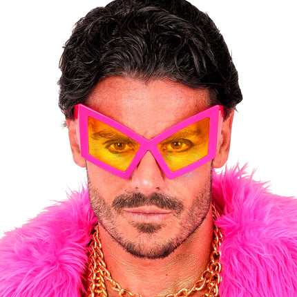 Close-up van de bril oversized neon roze bij een heer, hoekige glazen in oranjegeel