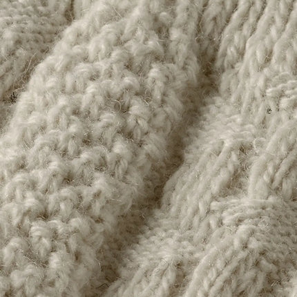 Close-up van de geribde boord en het reliëfbreisel van de Tiroler kniekousen off white