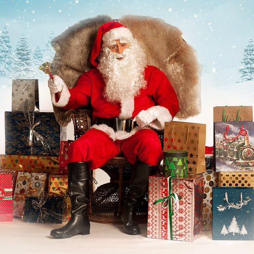 Goudkleurige ronde kerstmanbril in complete kerstmanoutfit met cadeauzak en bel