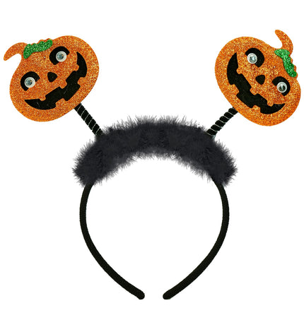 Hoofdband pompoen Liv met twee oranje glitterpompoenen op veertjes boven een zwarte verenband
