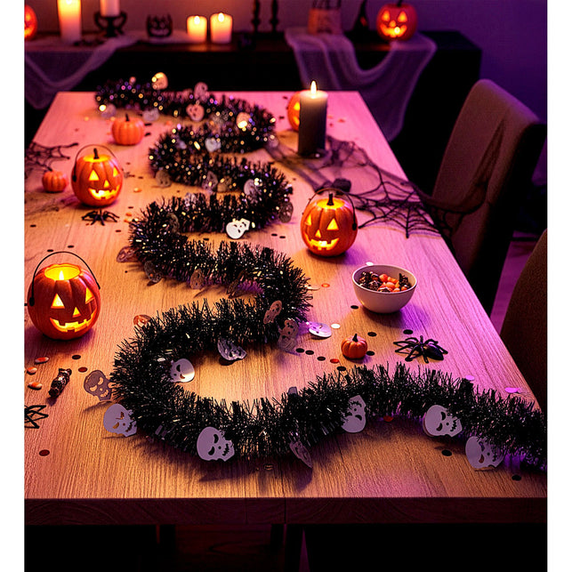 Schedelslinger op een gedekte tafel bij kaarslicht en pompoenlantaarns voor Halloween