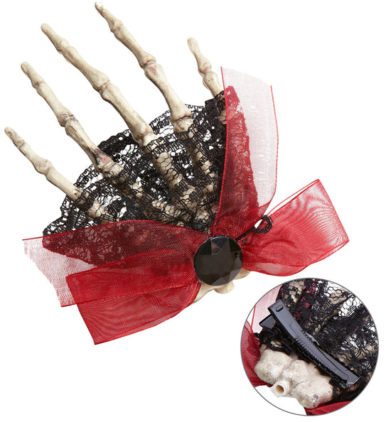 Skelet broche dode hand met rode strik, zwart kant en zwarte facetsteen, met knijpclip achterop