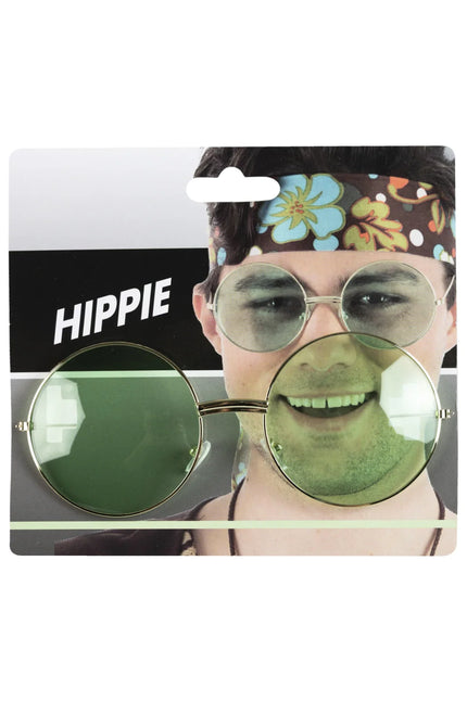 Uilebril goud met grote ronde groene glazen, hippiebril op verpakkingskaart met hippiethema