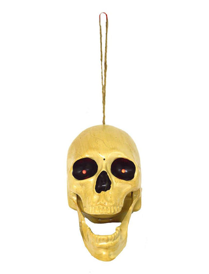 Zingende doodskop van pvc aan koord, botkleurig met rode oogpuntjes voor Halloween